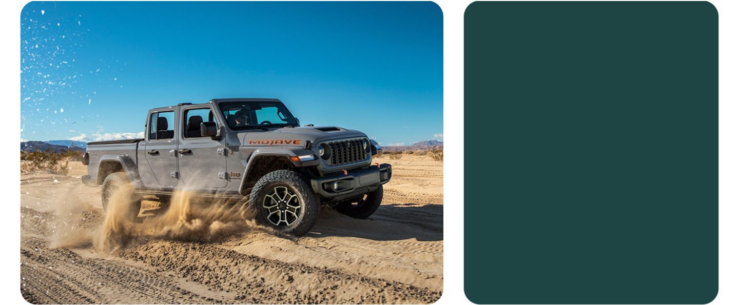 A gray 2026 Jeep Gladiator Mojave X traveling through the desert, kicking up sand as it goes.