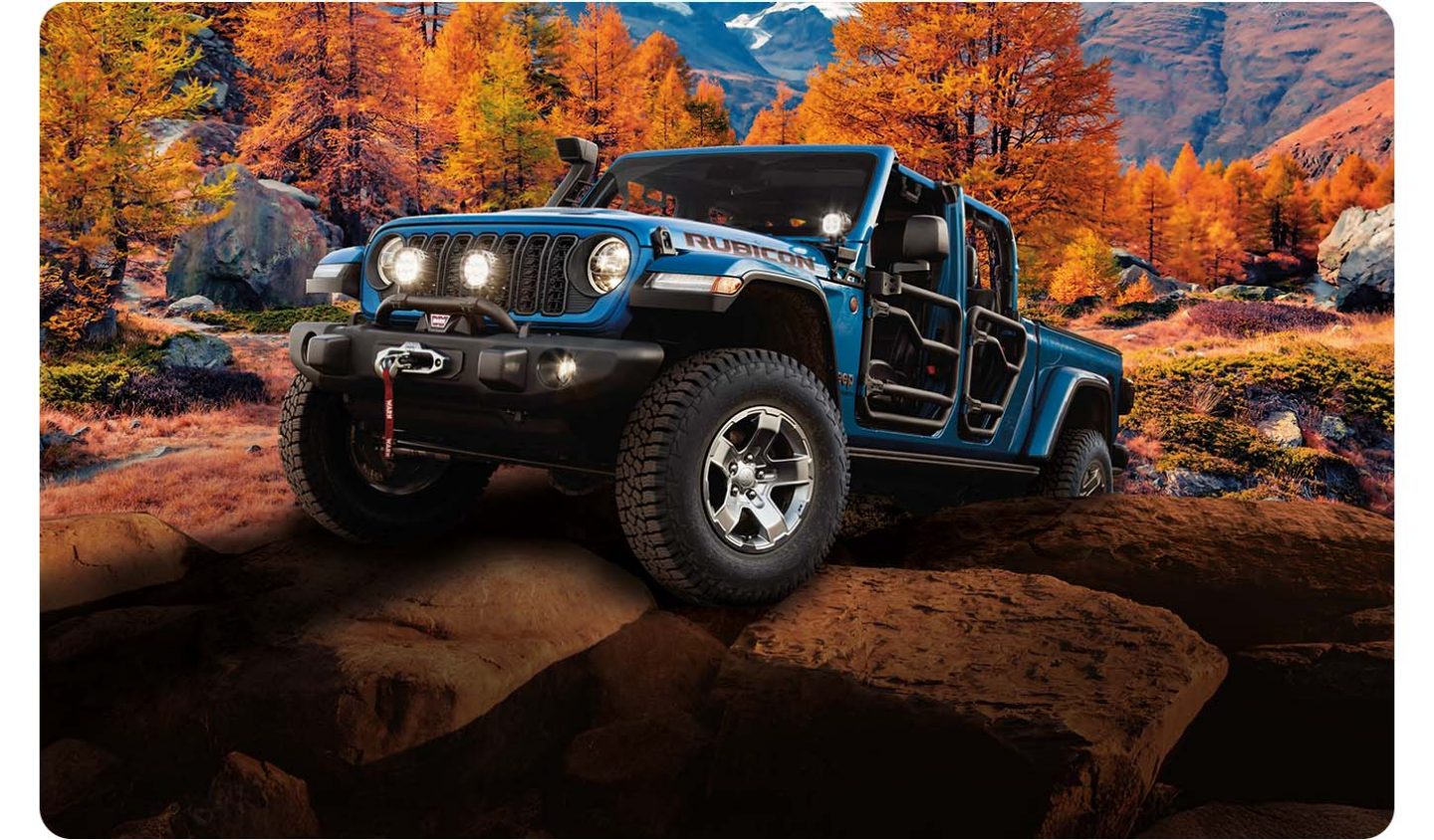 A blue 2026 Jeep Gladiator Rubicon with tube doors, crawling up a rocky hill, off-road in the mountains.