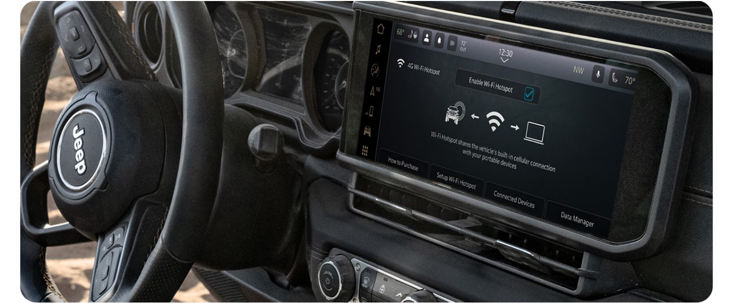 The steering wheel and Uconnect touchscreen in a 2026 Jeep Gladiator.