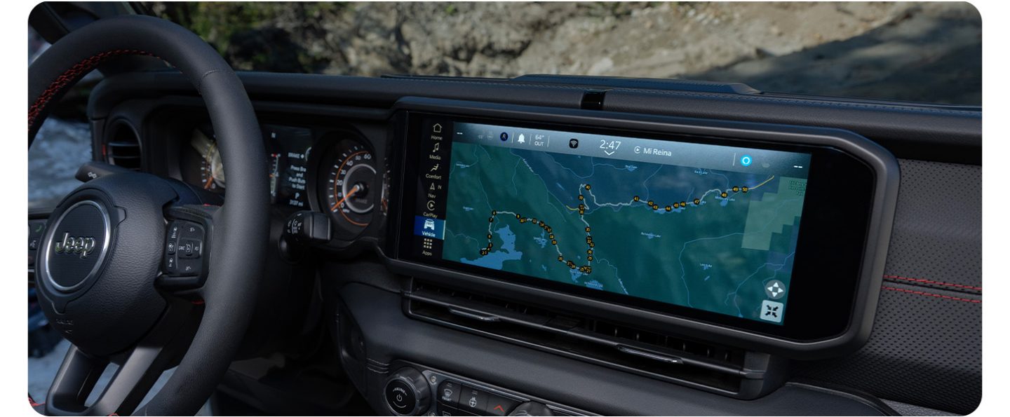 The Uconnect touchscreen in the 2026 Jeep Gladiator displaying one of the Off-Road Adventure Guides with a map of the Rubicon trail.