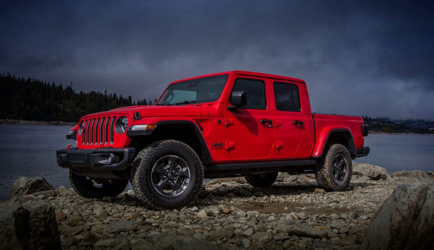 Rubicon. The 2022 Jeep Gladiator Rubicon parked on a rocky shore beside a lake.